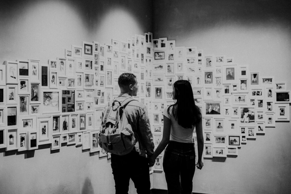Indoor Engagement in Colorado Couple Holding Hands looking at artwork | Julia Susanne Photography