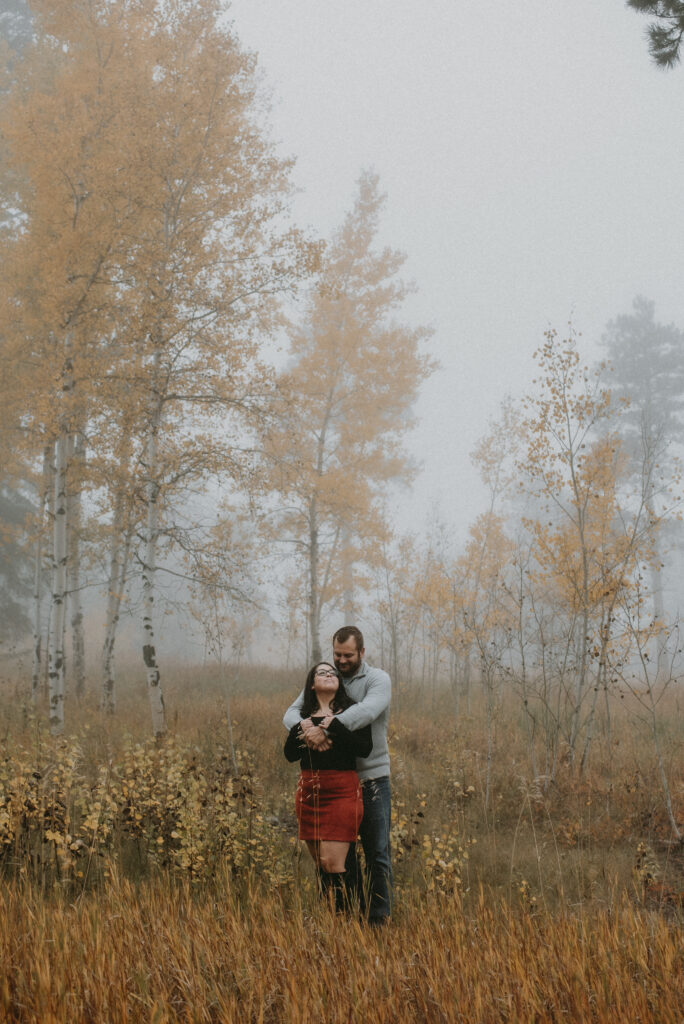 Outdoor Engagement in Colorado Couple in Aspen Mountain Fog Hugging | Julia Susanne Photography