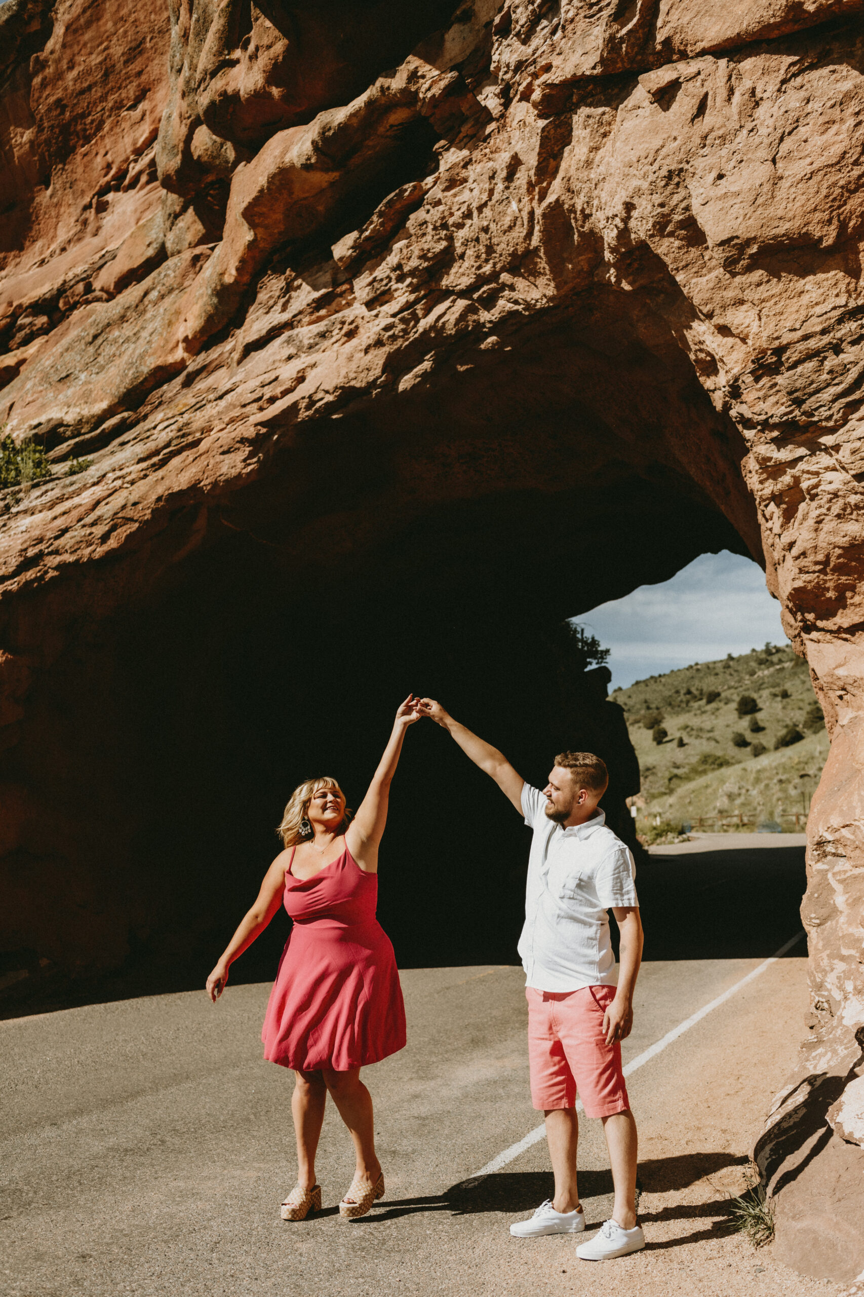 Outdoor Engagement in Colorado Couple Red Rocks Tunnel Spinning | Julia Susanne Photography