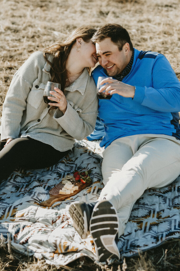 Outdoor Engagement in Colorado Couple Picnic with Wine and Charcuterie | Julia Susanne Photography
